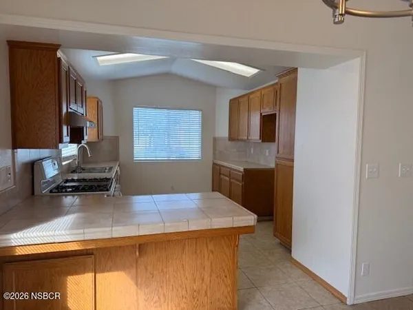 a kitchen with a stove and a refrigerator