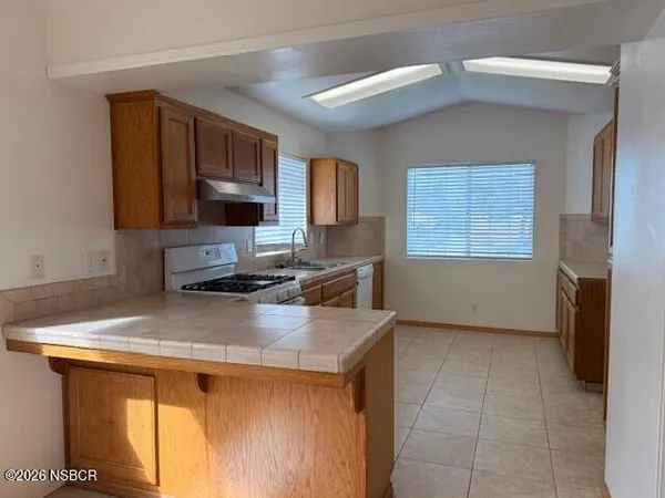 a kitchen with a sink a stove and cabinets
