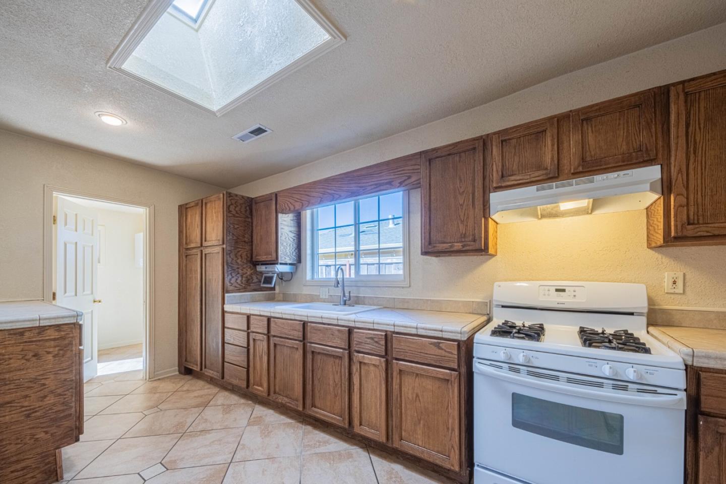 40 Oak Street Salinas, CA 93901 - Photo 13 of 28 a kitchen with a stove a sink and a refrigerator