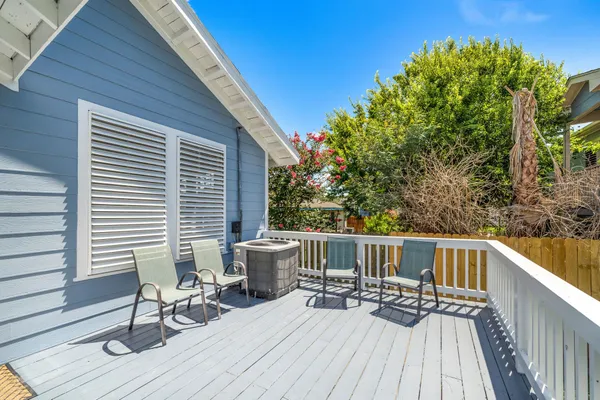 a view of a patio with table and chairs and wooden floor
