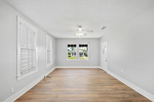 wooden floor in an empty room with a window