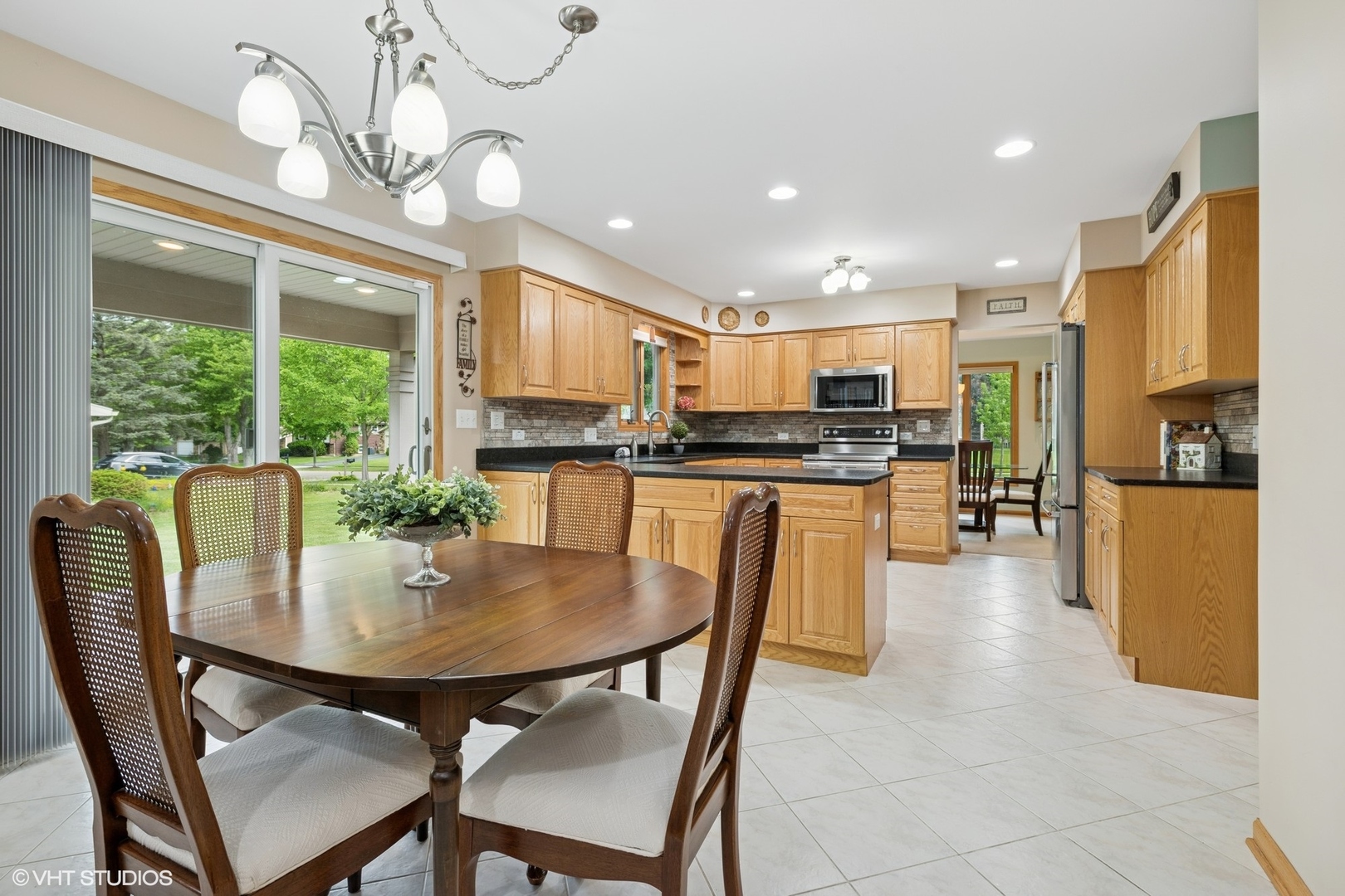 810 Tamarac Drive Algonquin, IL 60102 - Photo 10 of 36 a kitchen with stainless steel appliances granite countertop a stove a refrigerator a kitchen island a dining table and chairs