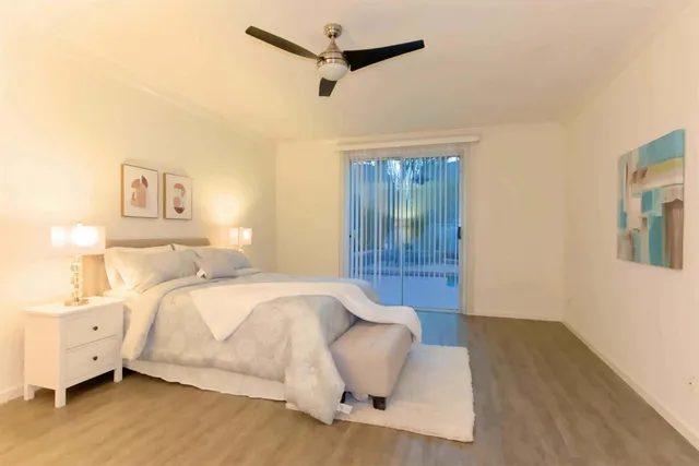 a spacious bedroom with a bed and a couch