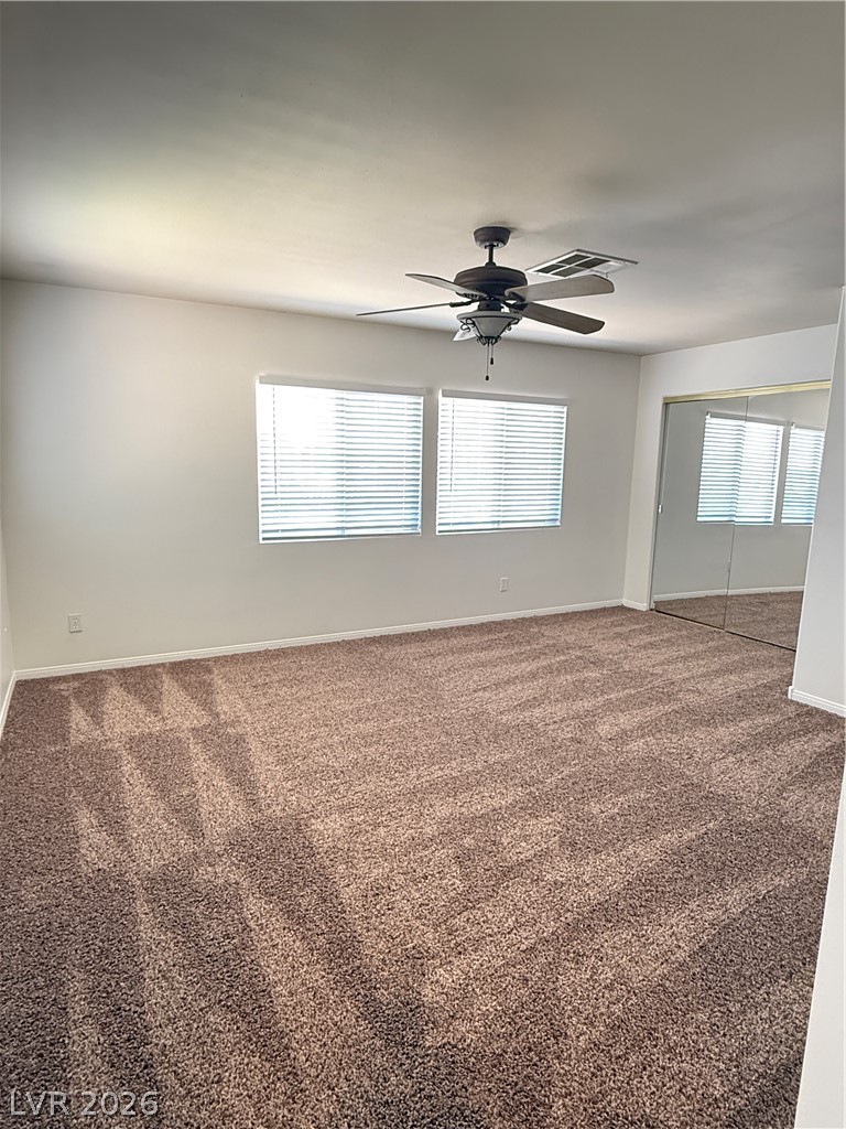 10975 Calcedonian Street Las Vegas, NV 89141 - Photo 18 of 25 This spacious room features ample natural light and plush carpeting, perfect for comfortable living.
