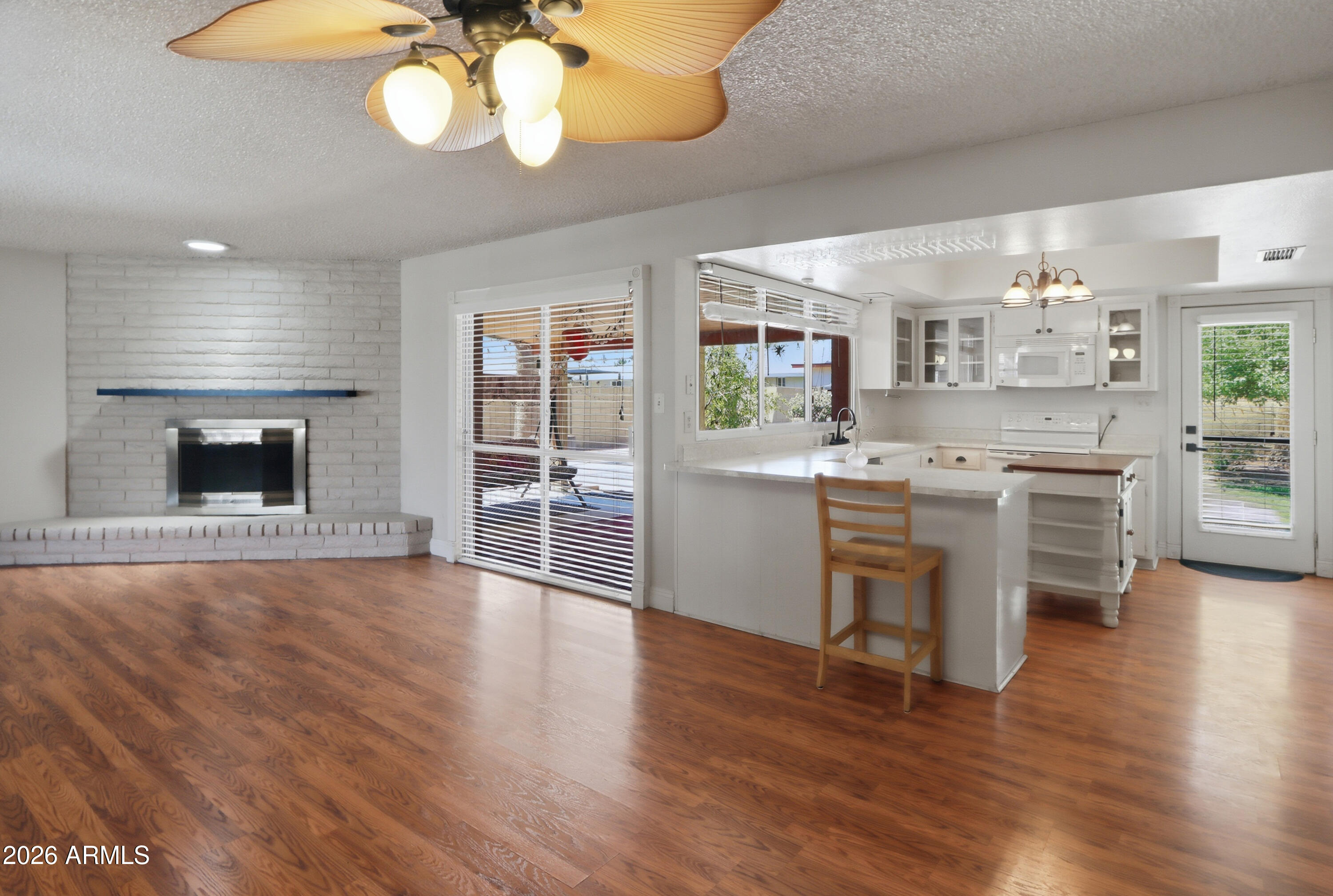 450 Cascada Road Litchfield Park, AZ 85340 - Photo 11 of 40 a kitchen with stainless steel appliances granite countertop a stove and cabinets with wooden floor