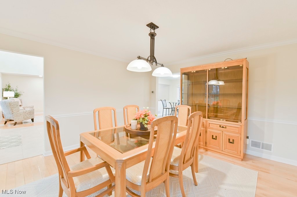482 Longspur Road Highland Heights, OH 44143 - Photo 19 of 47 Dining space featuring baseboards, crown molding, light wood-style floors, and visible vents