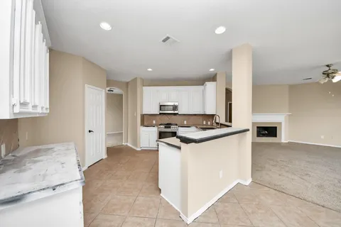 a kitchen with stainless steel appliances granite countertop a stove and a sink