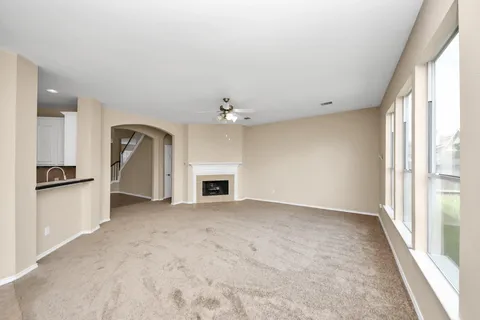 wooden floor in an empty room with a kitchen