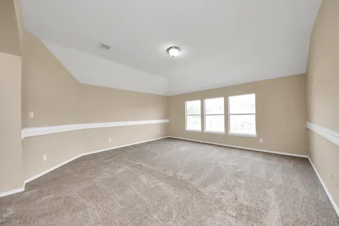 an empty room with a empty space and windows
