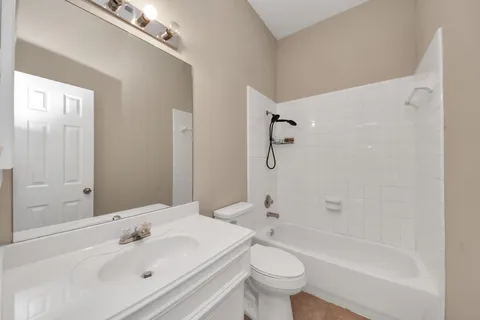 a bathroom with a sink mirror toilet and bathtub