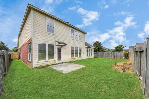 a view of an house with backyard space and garden