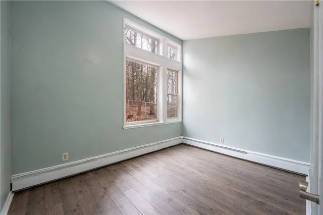 a view of an empty room with wooden floor