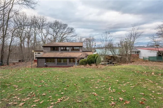 a view of a house with a yard and sitting area