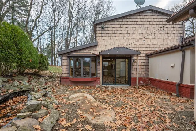 a view of a backyard with table and chairs under an umbrella