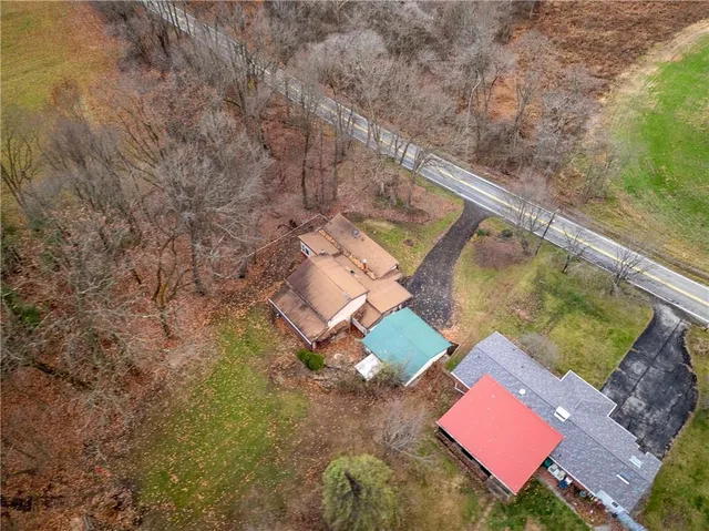 an aerial view of residential house with outdoor space and parking