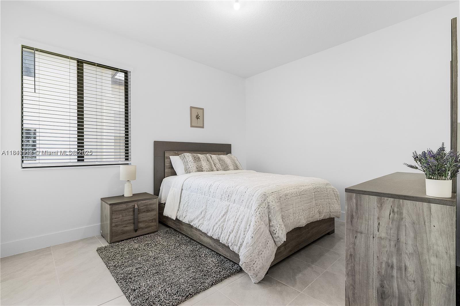 5061 Panella Avenue Immokalee, FL 34142 - Photo 3 of 13 a bedroom with a bed and a window