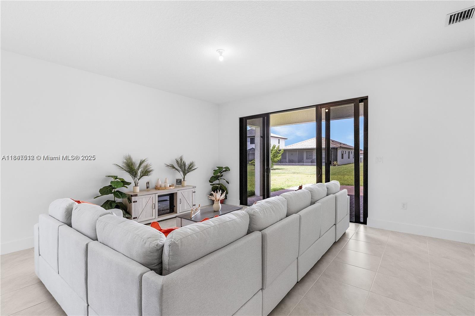 5061 Panella Avenue Immokalee, FL 34142 - Photo 4 of 13 a living room with furniture and a large window
