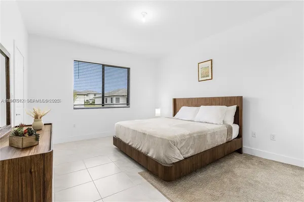 a bedroom with a bed and dresser