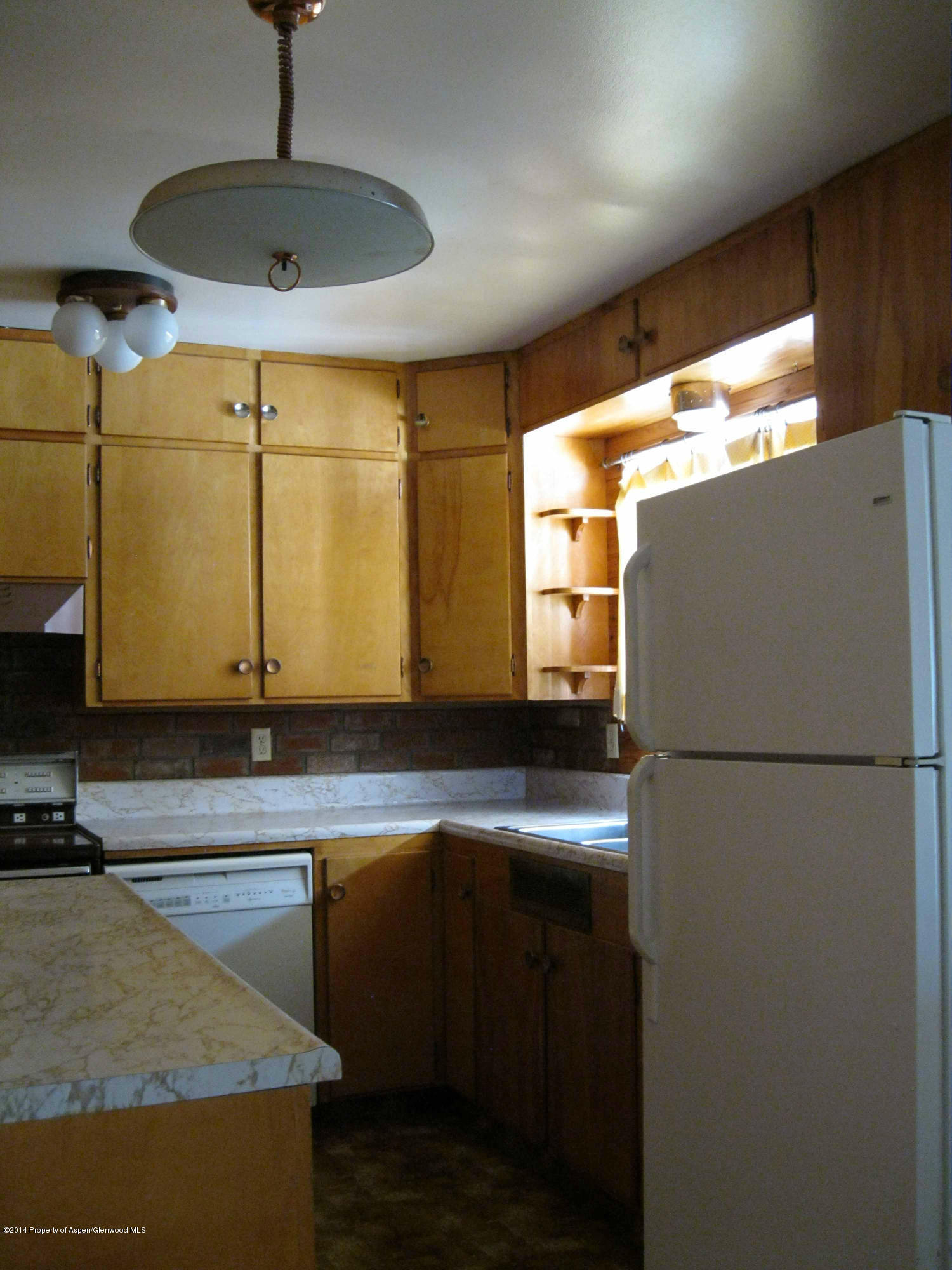 506 County Road 294 Rifle, CO 81650 - Photo 12 of 23 a kitchen with a refrigerator a sink and a stove