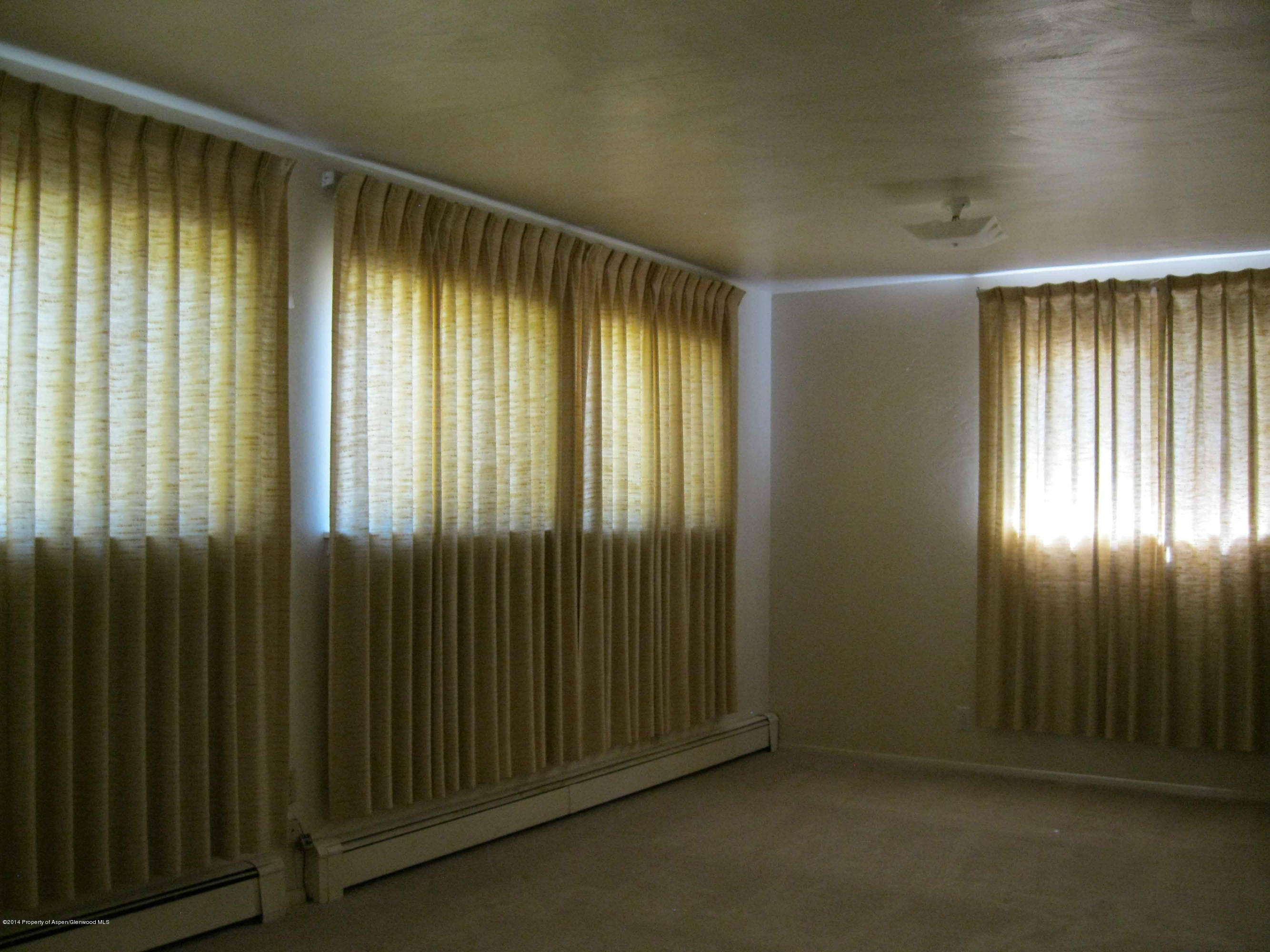 506 County Road 294 Rifle, CO 81650 - Photo 8 of 23 an empty room with wooden floor