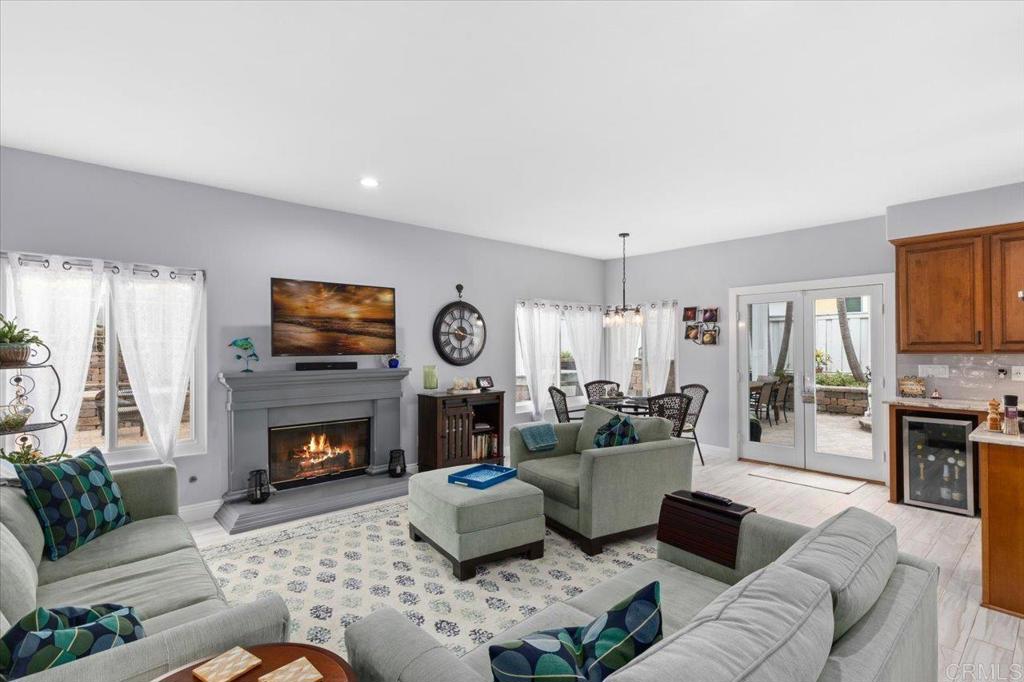 1838 Samoa Way Oceanside, CA 92054 - Photo 13 of 49 a living room with furniture flat screen tv and a fireplace
