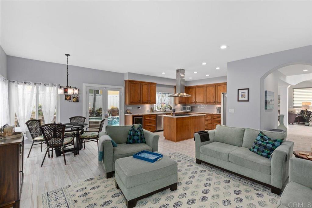1838 Samoa Way Oceanside, CA 92054 - Photo 15 of 49 a living room with furniture kitchen view and a wooden floor