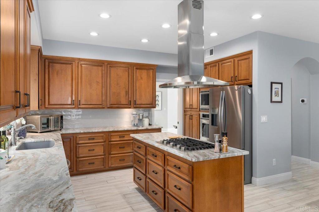 1838 Samoa Way Oceanside, CA 92054 - Photo 17 of 49 a kitchen with stainless steel appliances granite countertop a stove a refrigerator and a sink