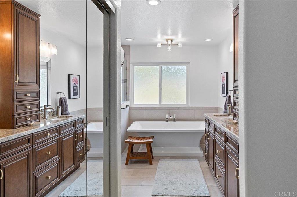 1838 Samoa Way Oceanside, CA 92054 - Photo 27 of 49 a spacious bathroom with a double vanity sink a mirror and a bathtub