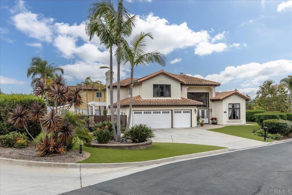 1838 Samoa Way Oceanside, CA 92054 - Photo 3 of 49 a front view of a house with a garden and trees