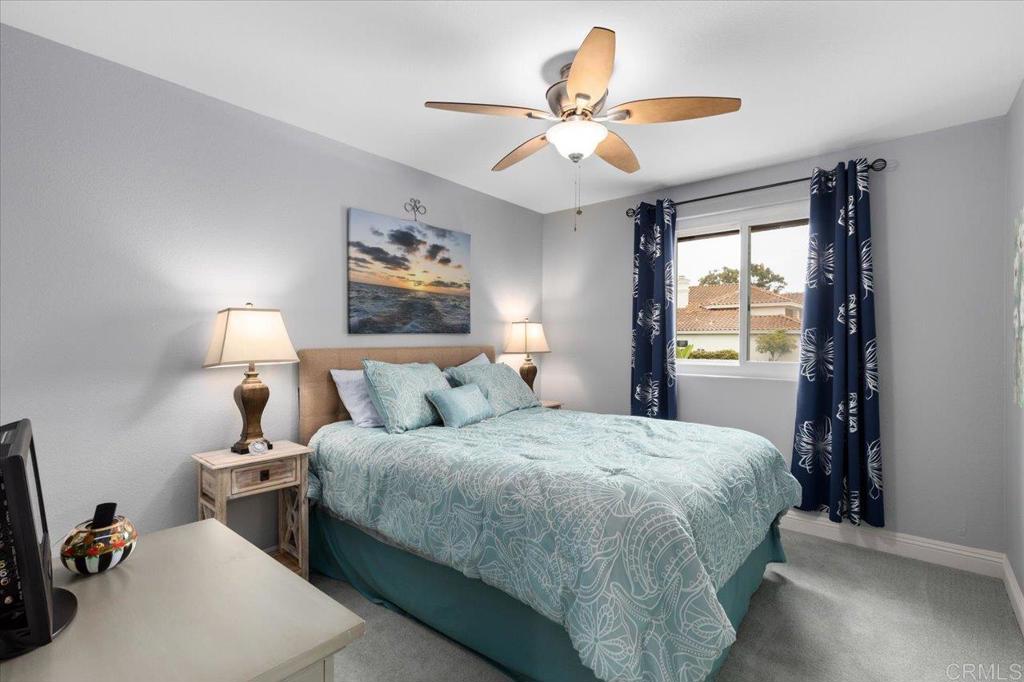 1838 Samoa Way Oceanside, CA 92054 - Photo 33 of 49 a bedroom with a bed and a chandelier