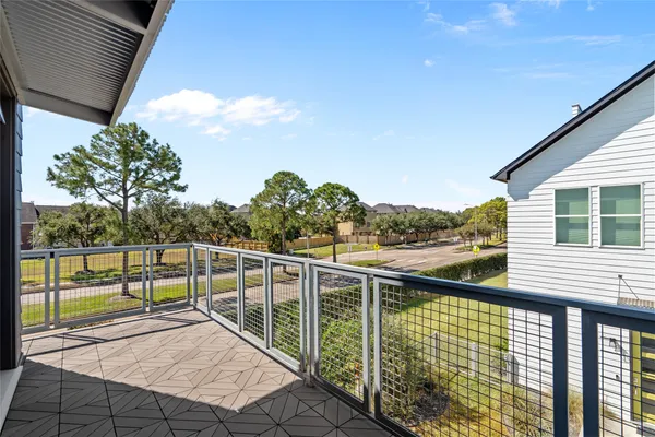 a view of a balcony with floor to ceiling windows with wooden fence