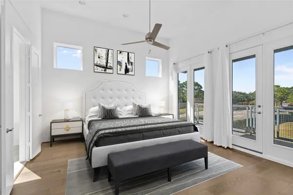 a bedroom with a bed wooden floor and window