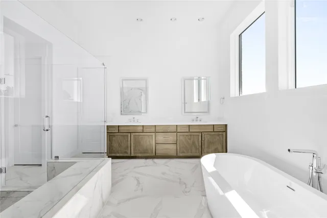 a bathroom with a granite countertop bathtub sink and mirror