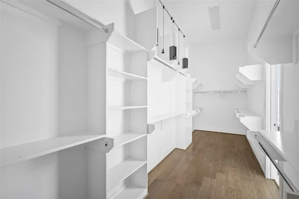 a view of walk in closet with empty racks