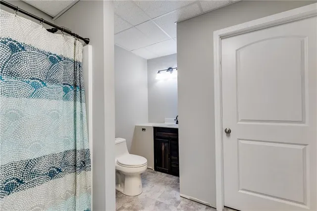 a bathroom with a toilet and shower