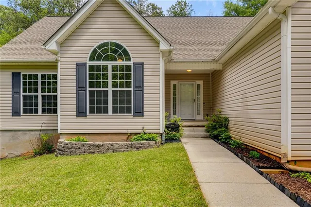 a view of house with backyard and garden