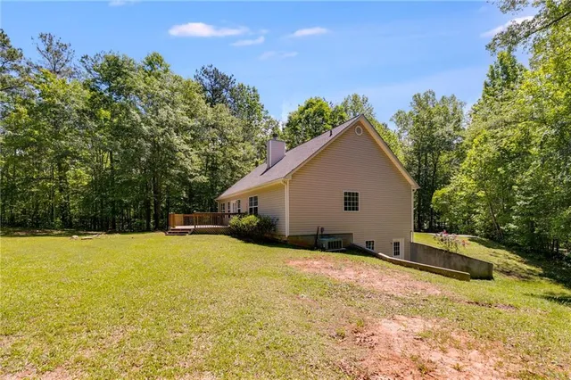 a view of a house with backyard and sitting area