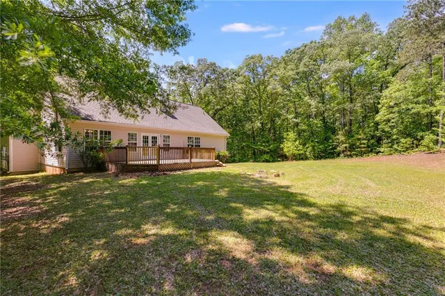 a view of house with outdoor space and sitting area