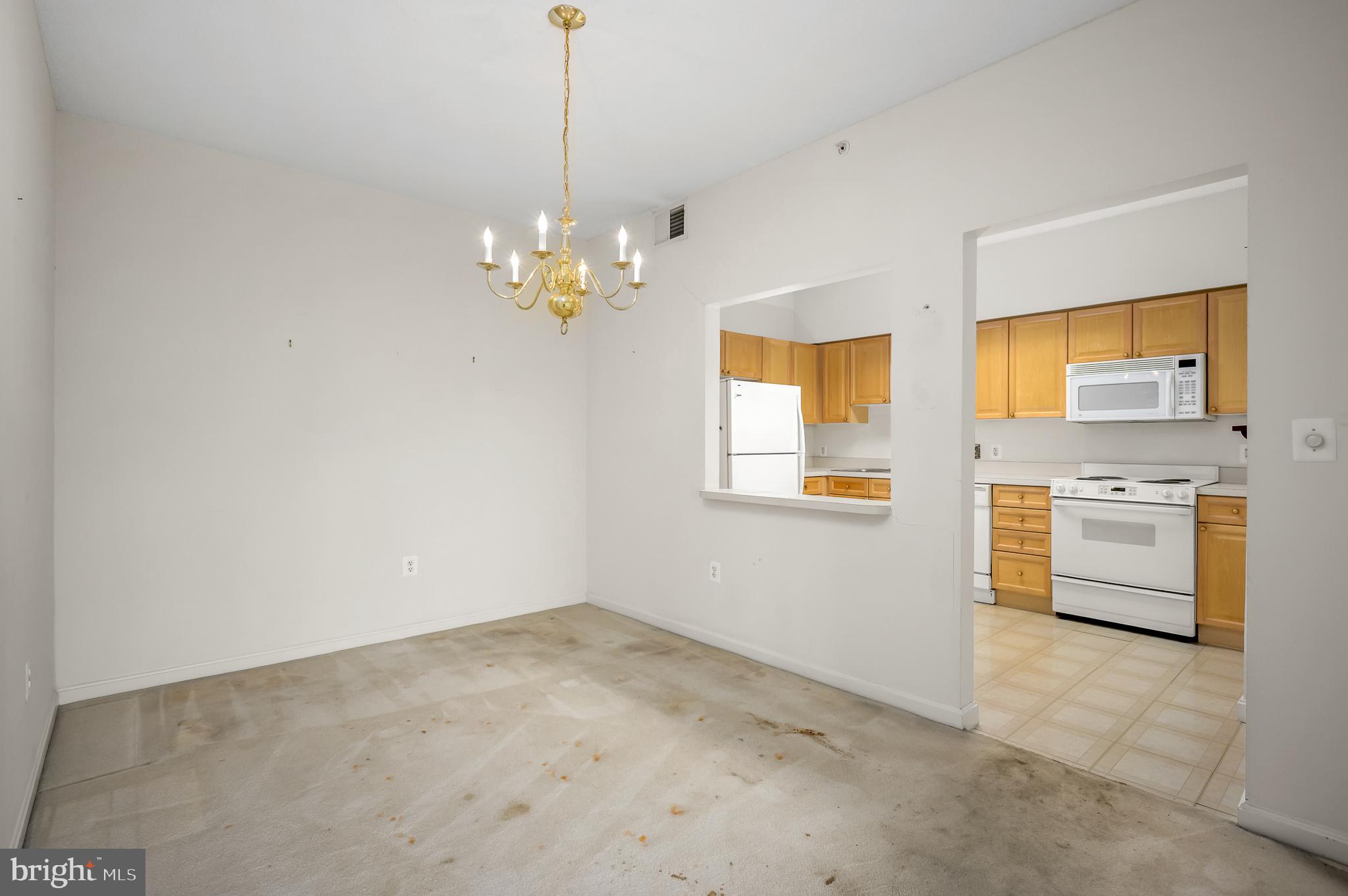 19365 Cypress Ridge Terrace, Unit 519 Leesburg, VA 20176 - Photo 2 of 24 a view of a kitchen with a sink cabinets and wooden floor