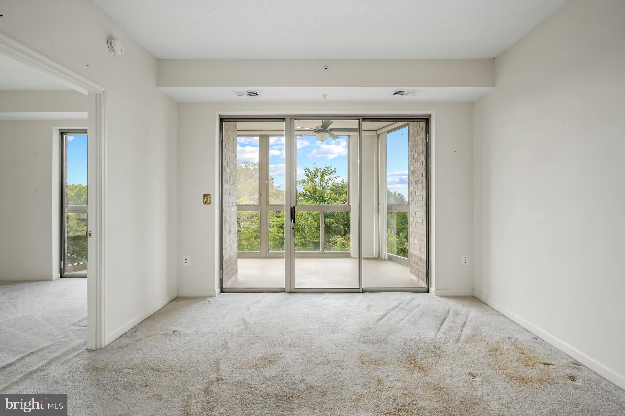 19365 Cypress Ridge Terrace, Unit 519 Leesburg, VA 20176 - Photo 4 of 24 a view of an empty room with wooden floor and a window