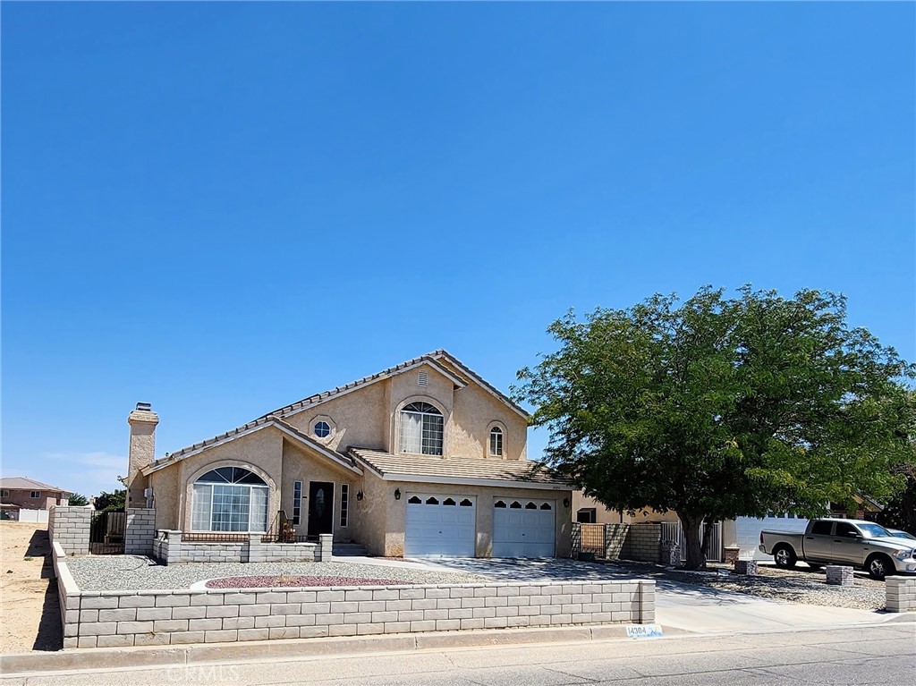 14304 Rivers Edge Road Helendale, CA 92342 - Photo 1 of 1 a front view of a house with a garden