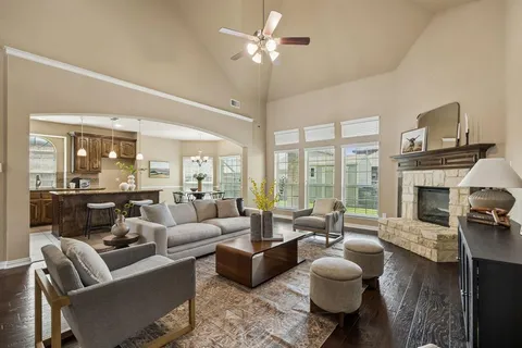 a living room with furniture fireplace and a large window