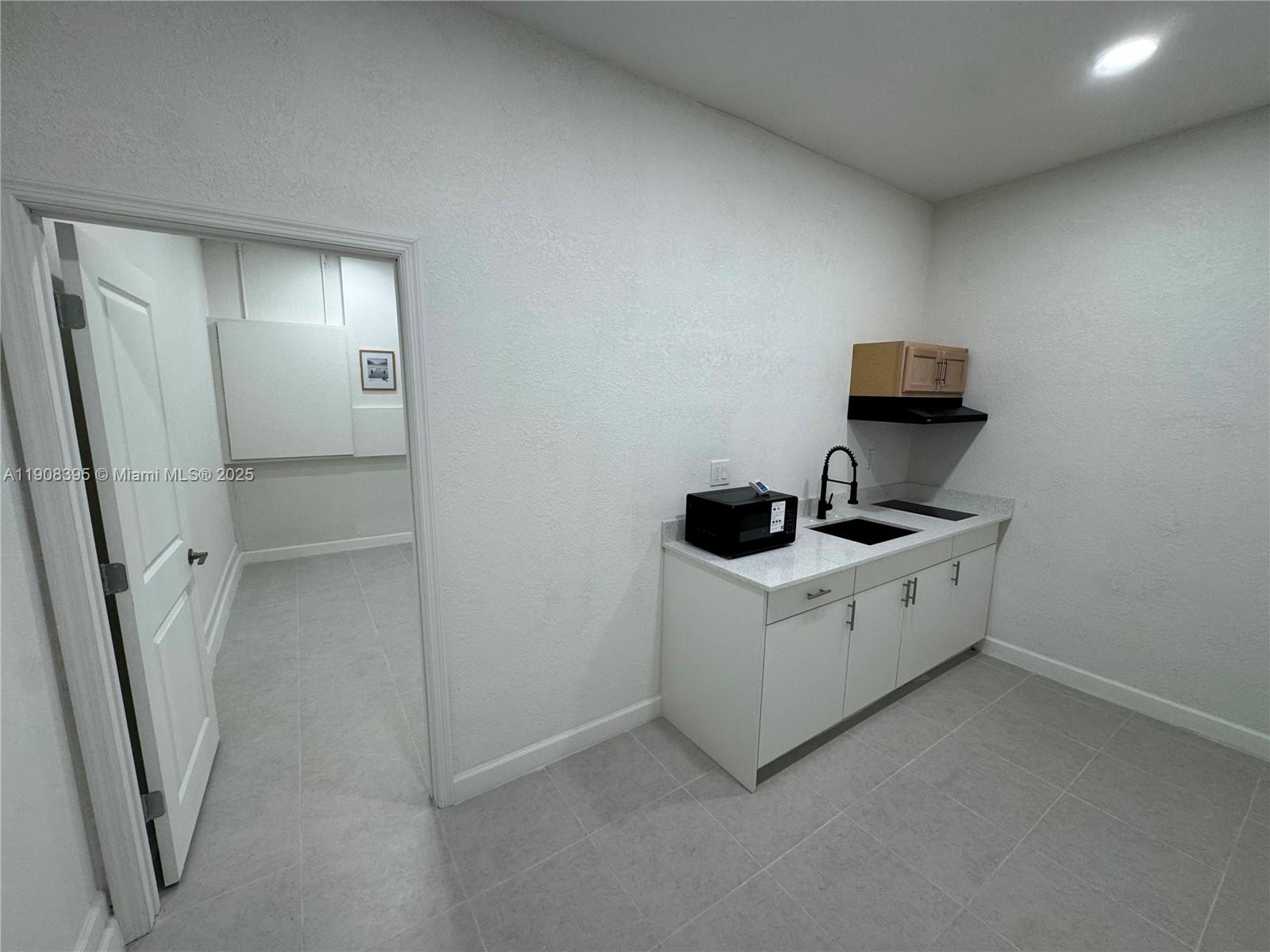 a utility room with cabinets washer and dryer