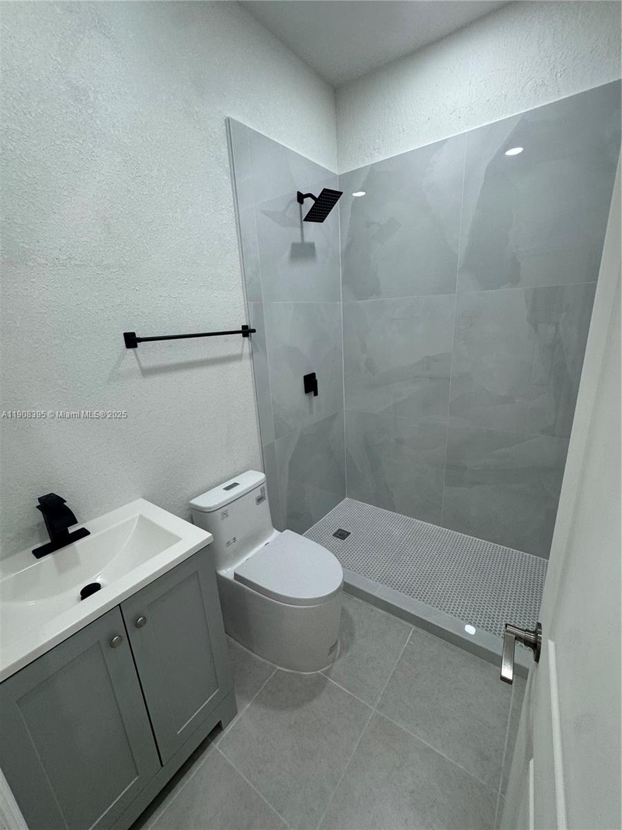 28850 Southwest 163rd Avenue, Unit 1 Homestead, FL 33033 - Photo 11 of 14 a bathroom with a sink toilet and shower