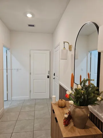 a living room with furniture and a mirror