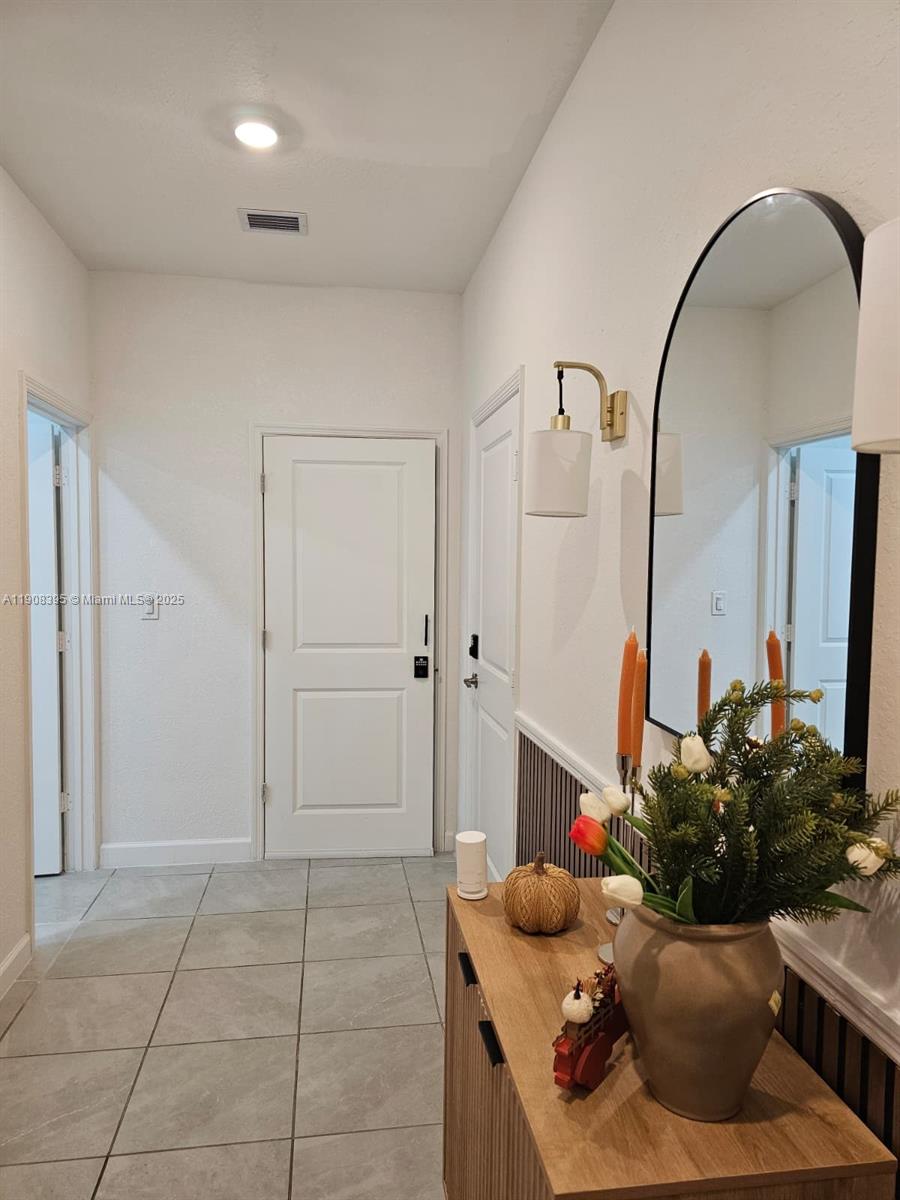 28850 Southwest 163rd Avenue, Unit 1 Homestead, FL 33033 - Photo 12 of 14 a living room with furniture and a mirror