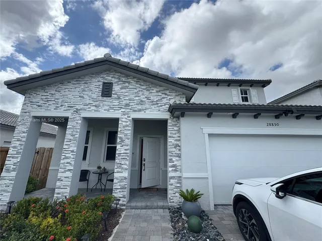 a front view of a house with parking space