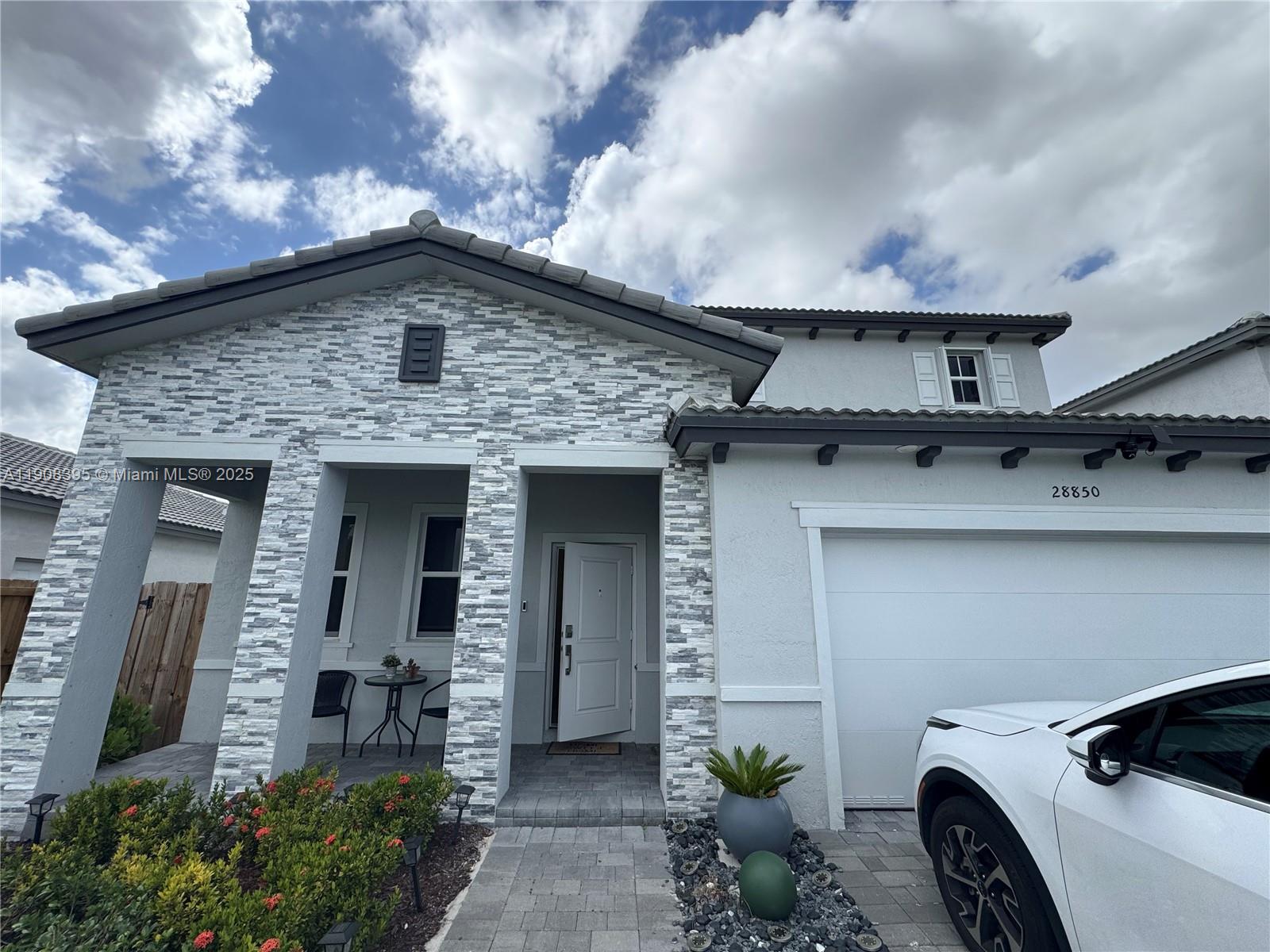 28850 Southwest 163rd Avenue, Unit 1 Homestead, FL 33033 - Photo 14 of 14 a front view of a house with parking space