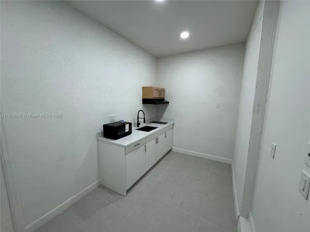 a utility room with sink dryer and washer