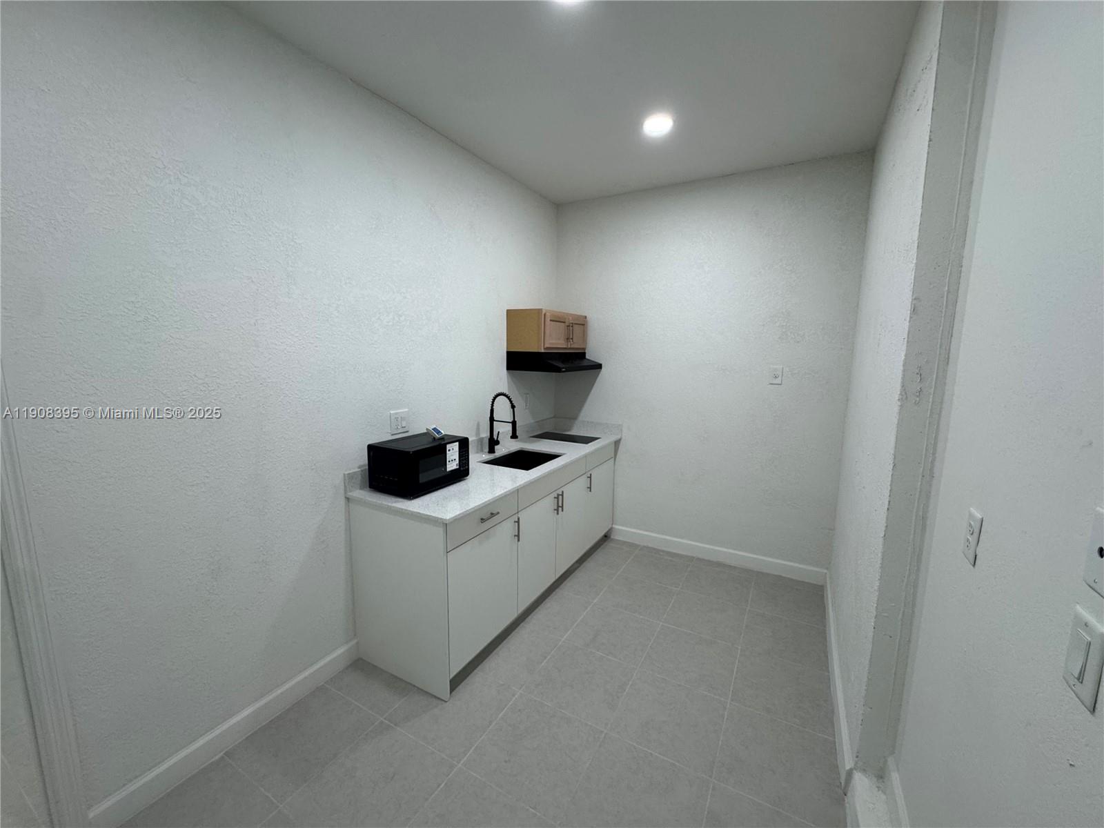 28850 Southwest 163rd Avenue, Unit 1 Homestead, FL 33033 - Photo 3 of 14 a utility room with sink dryer and washer